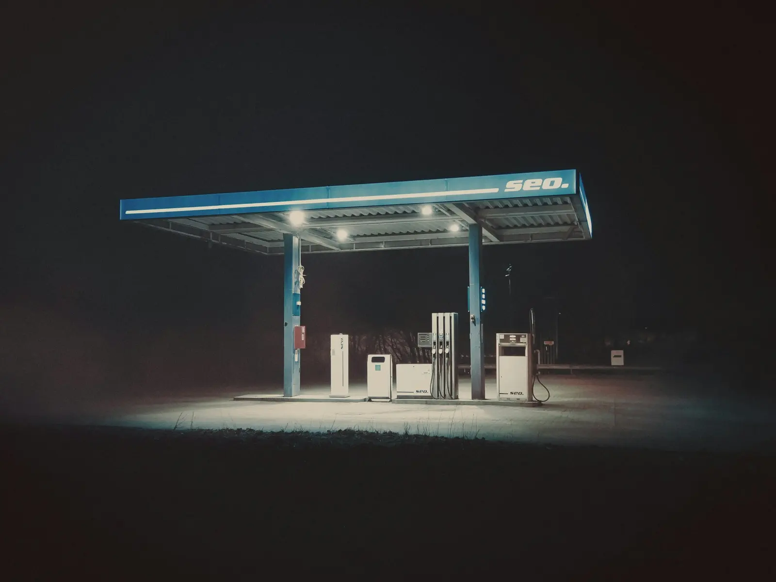 A petrol station glowing alone in the dark